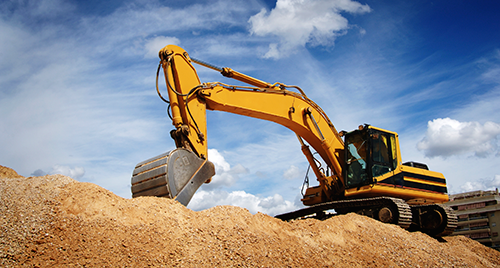 Excavator on land development site